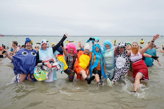 People take part in the Gosport New Year's Day Dip in The Solent at Stokes Bay, Gosport, Hampshire, to raise money for Gosport and Fareham Inshore Rescue Service.
