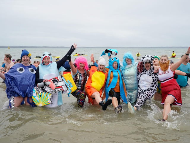 People take part in the Gosport New Year's Day Dip in The Solent at Stokes Bay, Gosport, Hampshire, to raise money for Gosport and Fareham Inshore Rescue Service.