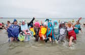 People take part in the Gosport New Year's Day Dip in The Solent at Stokes Bay, Gosport, Hampshire, to raise money for Gosport and Fareham Inshore Rescue Service.