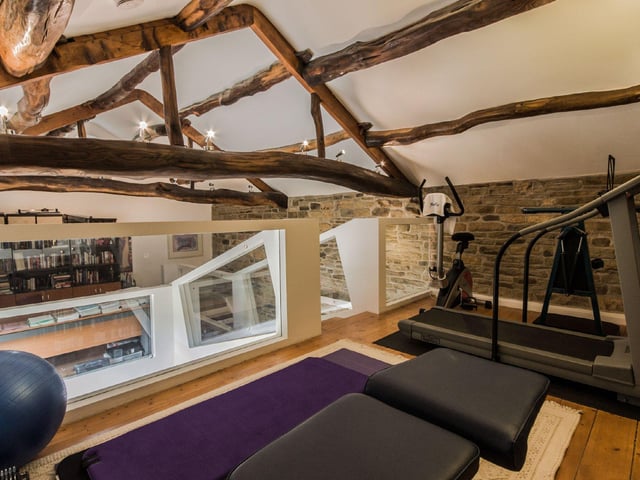 The gymnasium is accessed via a unique floating wooden staircase from the office area, and is spacious in size with room for several pieces of equipment.