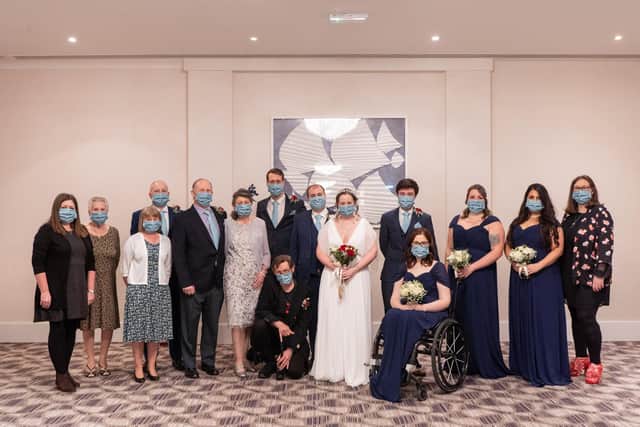 The couple with their 15 guests.  Picture: Carla Mortimer Photography