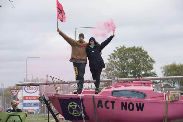 Extinction Rebellion of British Olympians Laura Baldwin and Etienne Stott outside Fawley Oil terminal. Pic: Extinction Rebellion/PA Wire