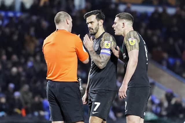 Referee Bobby Madley is confronted by Marlon Pack and Colby Bishop following his controversial decision to rule out Pompey's goal.