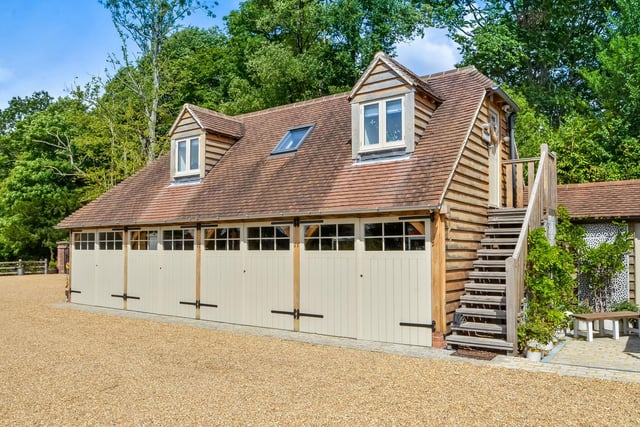 A guest suite/studio is above the detached garage and a private office which overlooks the grounds