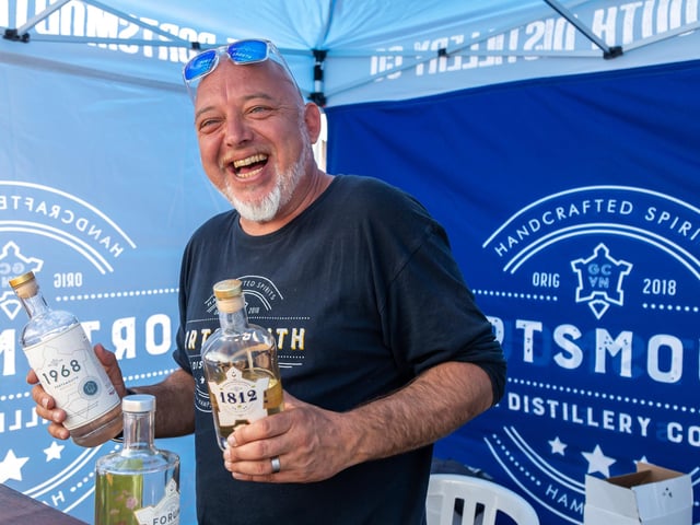 Dich Oatley from the Portsmouth Distillery gives out samples of the very first rum in English history to be made from scratch and aged 3 years. Picture: Mike Cooter (210522)