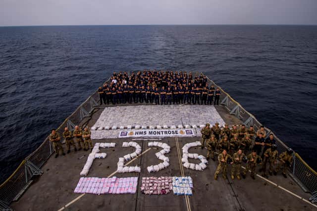 HMS Montrose's crew pictured on the ship's flight deck following a string of raids to seize drugs from smugglers in the Gulf. Photo: CMF-150