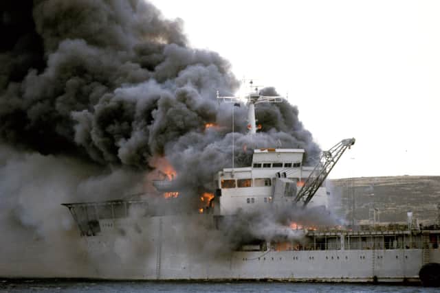 RFA Sir Galahad ablaze after the Argentine air raid on June 8, 1982, at Bluff Cove near Fitzroy settlement on East Falkland. Photo: Martin Cleaver/PA Wire