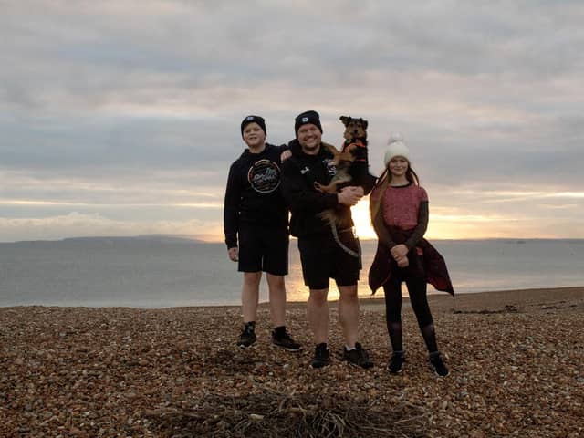 Dozens of people on Hayling Island are taking on a marathon challenge for Prostate Cancer UK. Pictured: Mark, Joe and Livvy Coates with Luna the dog