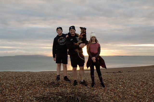 Dozens of people on Hayling Island are taking on a marathon challenge for Prostate Cancer UK. Pictured: Mark, Joe and Livvy Coates with Luna the dog