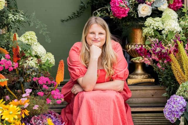 Chiara outside the workshop, with some of her impressive blooms.
