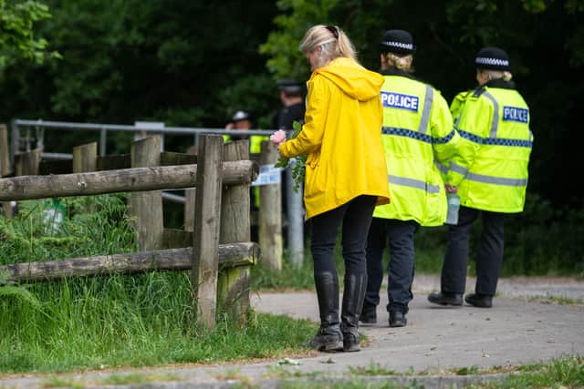 A woman pays tribute at the scene in Havant Thicket, where a body was found during the search for missing 16 year-old Louise Smith. Picture: Jordan Pettitt/Solent News & Photo Agency