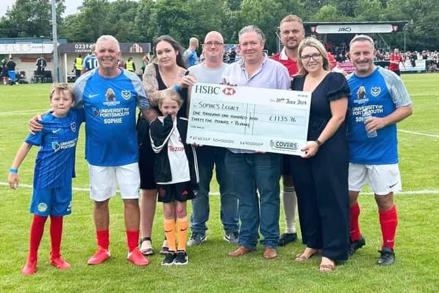 Anna Simpson from Covers presenting Charlotte Fairall from Sophie Legacy with a cheque for £1,136