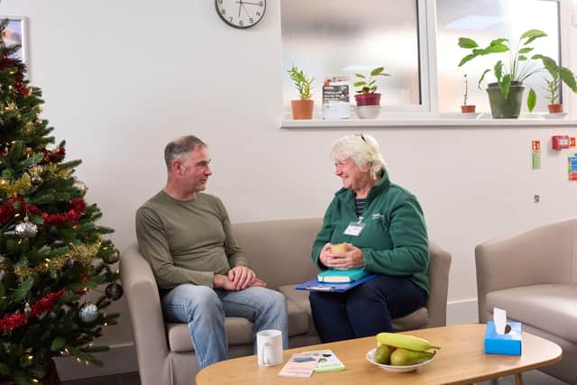 Food bank volunteer greeting visitor