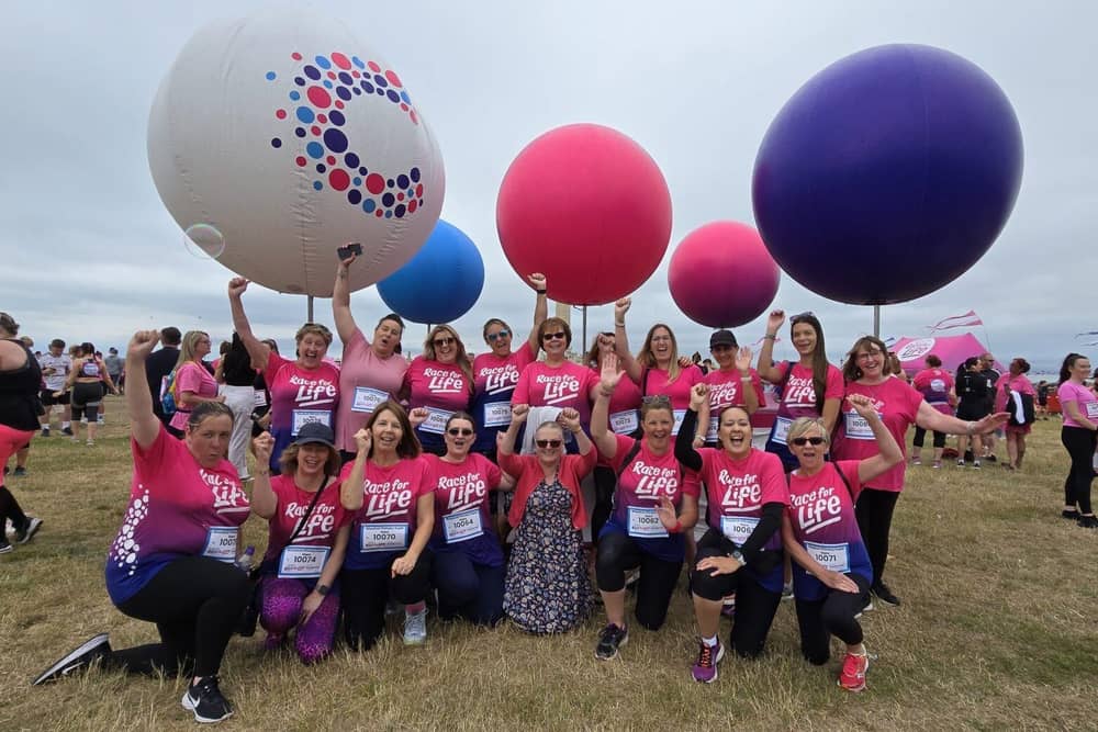 Marion Clist, centre, was surrounded by staff from Woodcott Primary School in support of her