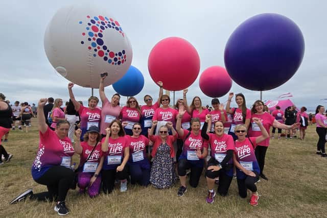 Marion Clist, centre, was surrounded by staff from Woodcott Primary School in support of her