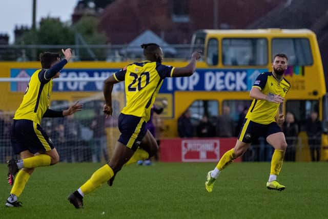 Nick Dembele (middle) celebrates his winner. Picture: Colin Farmery