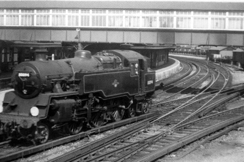 Looking down from Goldsmith Avenue towards Fratton Station footbridge 1960. here we see a Standard class 2-6-4 travelling tender first into the depot. Notice the covering of the footbridge now a long gone feature.