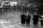 Flooding outside the goods sheds in Commercial Road. The boy’s face in the centre says it all. Flooding in Commercial Road taken from inside the gates of the railway goods shed.