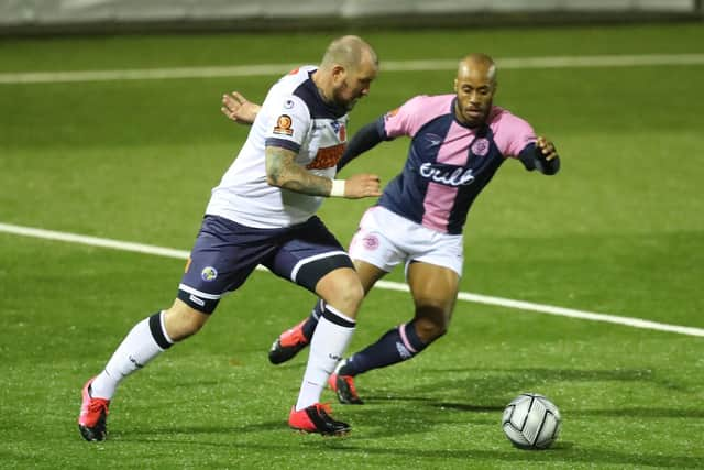 Danny Kedwell takes on Dulwich's Sanchez Ming. Picture by Dave Haines