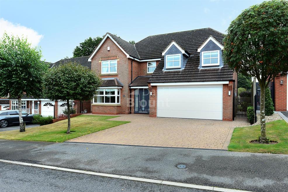 The stunning exterior of the Mayflower Court property. The block-paved driveway leads to a huge double garage, while the front door is made of contemporary steel.