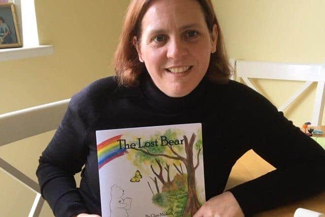 Children's author Clair Maskell has written The Lost Bear for baby loss awareness week, in honour of the Overy family from Gosport. Pictured: Clair with a copy of the book