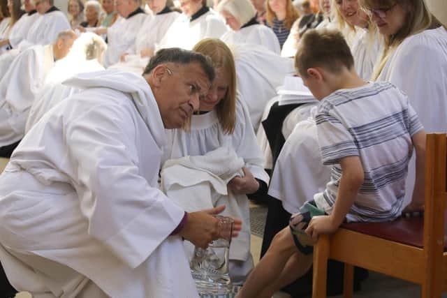 Bishop Jonathan Frost asks Lucas Ashworth if he'd like to have his feet washed