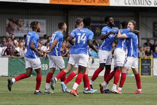 Liam Vincent, right, is mobbed by his Blues team-mates following his second-half free-kick