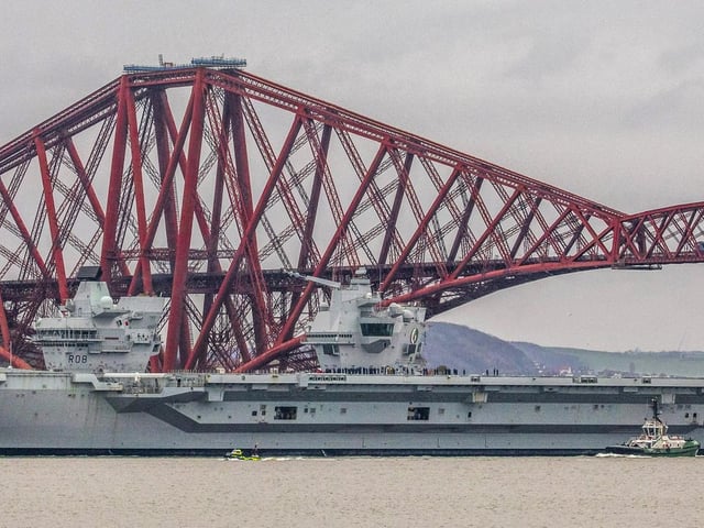 HMS Queen Elizabeth makes her way under the Forth Bridges as she prepares to dock at Rosyth dockyard for repairs. Picture: SWNS