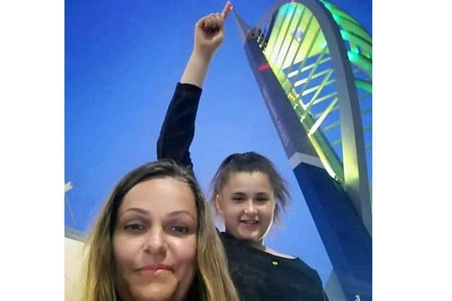 Laura Harris, 40 from Lee-on-the-Solent, has started treatment affter living with Lyme disease for years. Pictured: Laura and her daughter Elisha with the Spinnaker Tower when it was lit up green for Lyme disease awareness