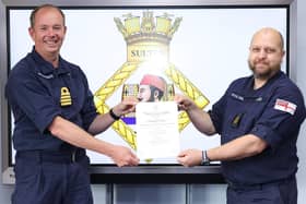 Commanding Officer HMS Sultan, Captain John Voyce RN, presents the Royal Humane Society certificate to CPOET(ME) Stew Jayes.