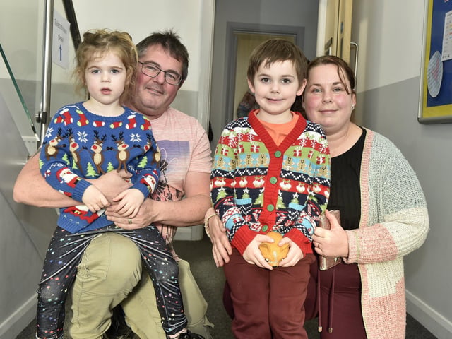 Beacon View Primary Academy in Paulsgrove held their annual community Christmas lunch on Friday, December 22.Pictured is: Andrew and Donna Grimes with their children Charlotte (4) and Daniel (6).Picture: Sarah Standing (221223-4068)