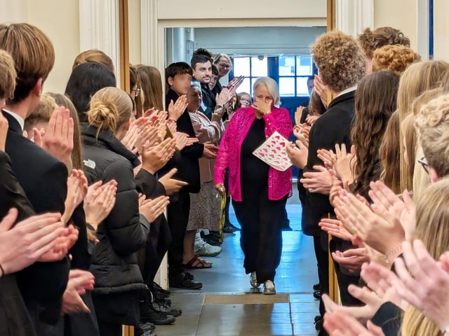 An emotional Dianne Howell leaves school with pupils, forming a guard of honour