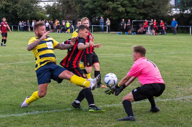 Paulsgrove's two-goal match-winner Shane Cornish (yellow/blue) saw this effort roll just wide of the Fleetlands post. Picture: Mike Cooter.