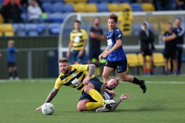 Paulsgrove's Shane Cornish is brought down by Ross Caldwell. Picture: Chris Moorhouse