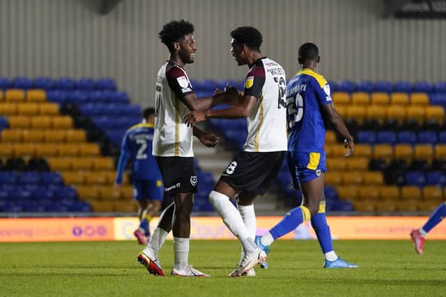 Ellis Harrison celebrates with Reeco Hackett-Fairchild following the goal which earned him a hat-trick at AFC Wimbledon last night. Picture: Jason Brown/ProSportsImages