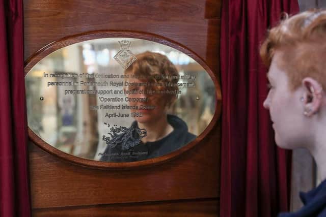 BAE Systems apprentice Rohann Pearce, 23, crafted the plaque over the course of two weeks. Here she is pictured looking at her handiwork. Photo: Royal Navy