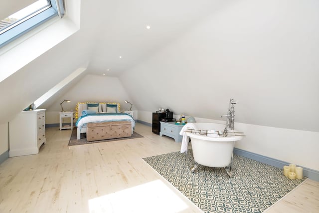 This stunning bedroom has its own freestanding bath