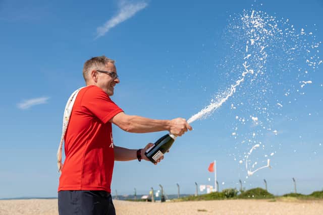 Miles van der Lugt celebrates his 1,000 day running streak with some champagne. Picture: Mike Cooter