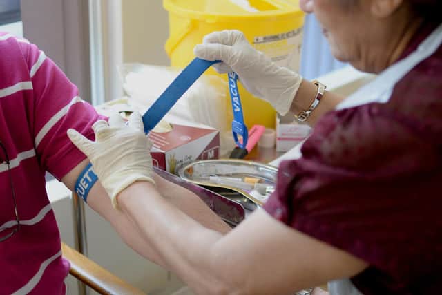 A nurse ties a tourniquet before taking blood at the Temple Fortune Health Centre GP Practice near Golders Green, London. Picture: Anthony Devlin/PA.