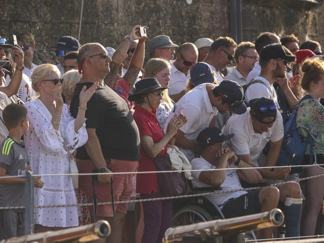 Pictured: Crowds watch on in front of the Royal Yacht Squadron as HMS Queen Elizabeth enters the Solent off of Cowes.