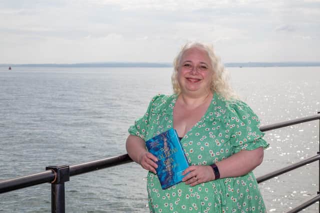 Real Life: Portsmouth author Annie KirbyLocal Portsmouth debut author, Annie Kirby and her novel The Hollow Sea Pictured: Annie Kirby with her book, The Hollow Sea at Hotwalls, Old Portsmouth on Friday 2nd September 2022Picture: Habibur Rahman