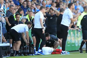 Pompey's Louis Thompson is left in agony after a late challenge from Glenn Whelan against Bristol Rovers.