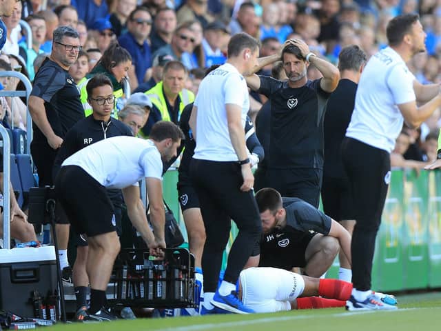 Pompey's Louis Thompson is left in agony after a late challenge from Glenn Whelan against Bristol Rovers.
