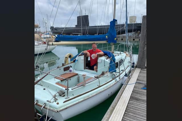 Trevor McAlister in the Halcyon boat he is auctioning off.