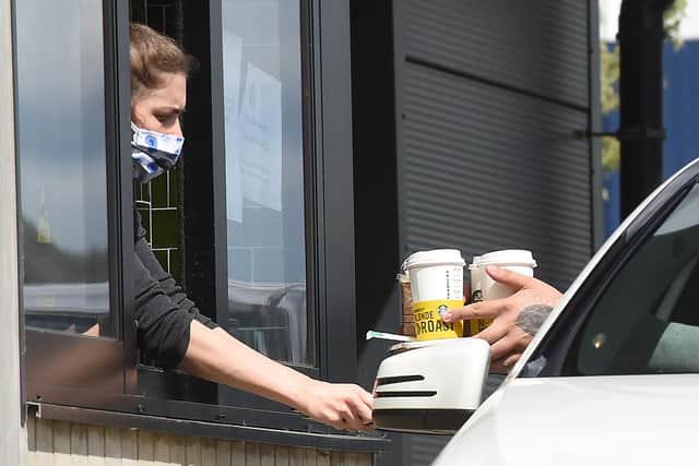 Customers queue to collect their orders from the reopened Starbucks drive through.

© Simon Czapp/Solent News & Photo Agency