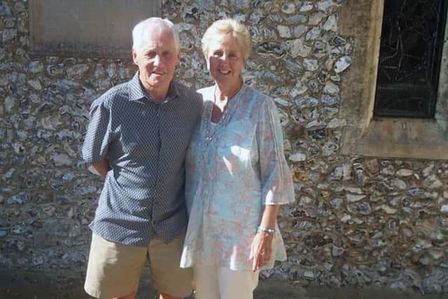 Keith and Ruth standing in the same spot where they had their original wedding photographs taken outside Catherington Church.