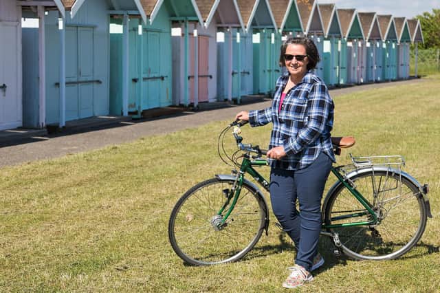 Loree Westron in front of the beach huts which feature in Missing Words. Picture: Mike Cooter (250621).
