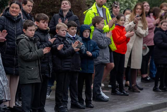 Winter Road/Wimborne Road lollipop man Tom James, who recently passed away, will be honoured by pupils and residents in the areaPictured: Wimborne Primary School watch the hearse carrying Tom James on Winter Road, Portsmouth on Friday 11th March 2022Picture: Habibur Rahman