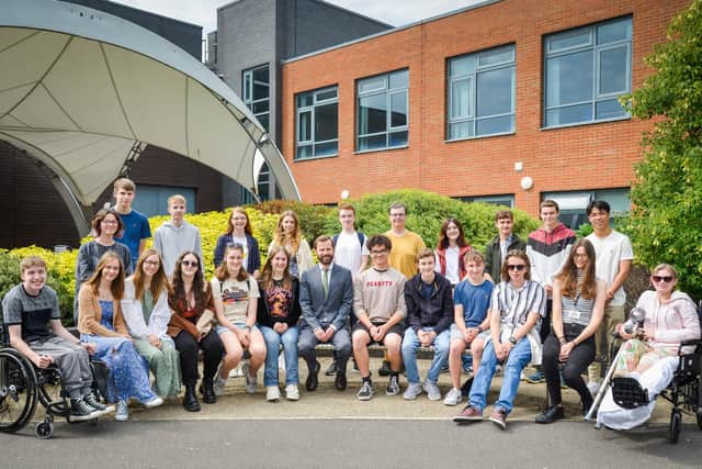 Students celebrating their achievements, pictured with principle Rob Temple.