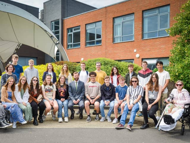 Students celebrating their achievements, pictured with principle Rob Temple.